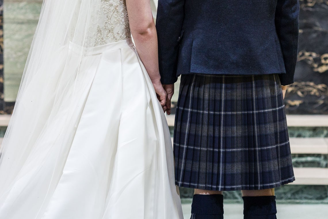 bride and groom holding hands