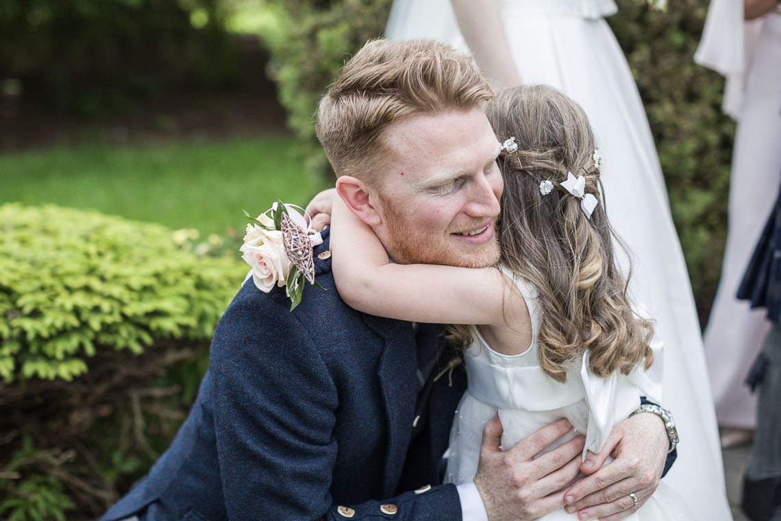 groom congratulated by a guest