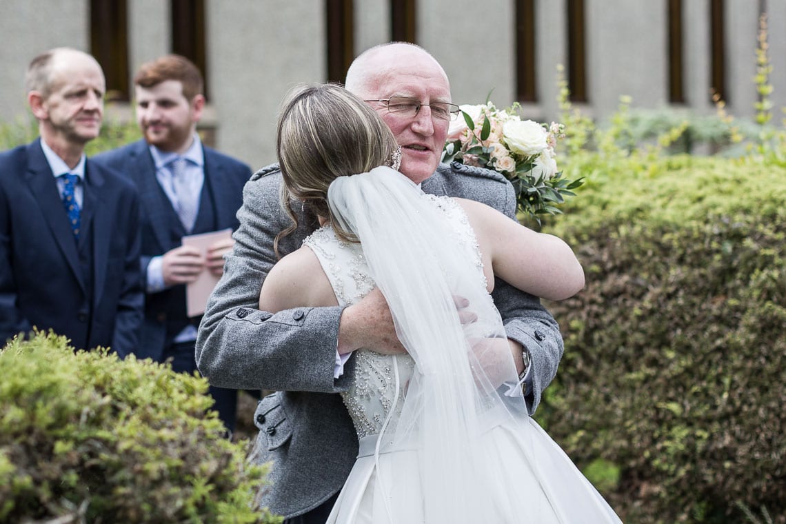 bride congratulated by father of the groom