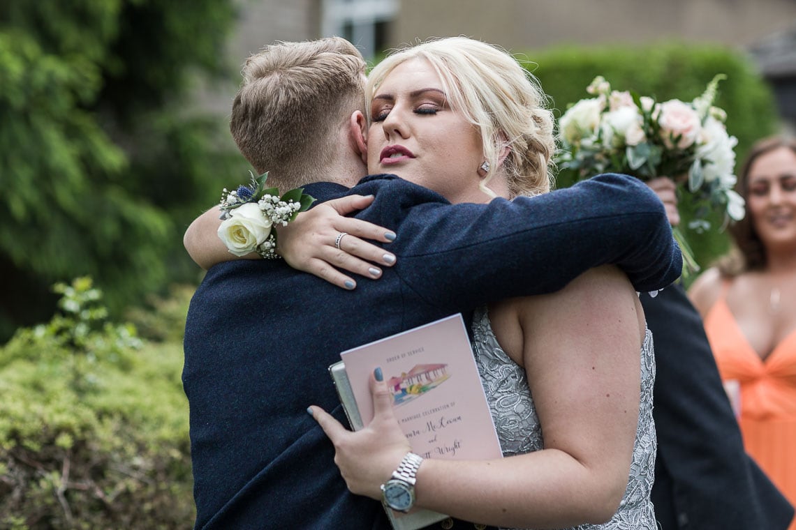 groom congratulated by a guest