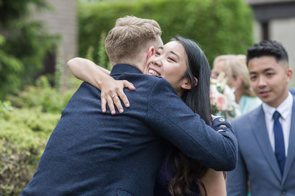 groom congratulated by a guest