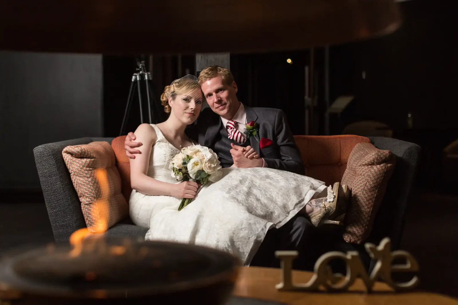 Joanne and Alan sitting together inside The Glasshouse in Edinburgh on their wedding day.