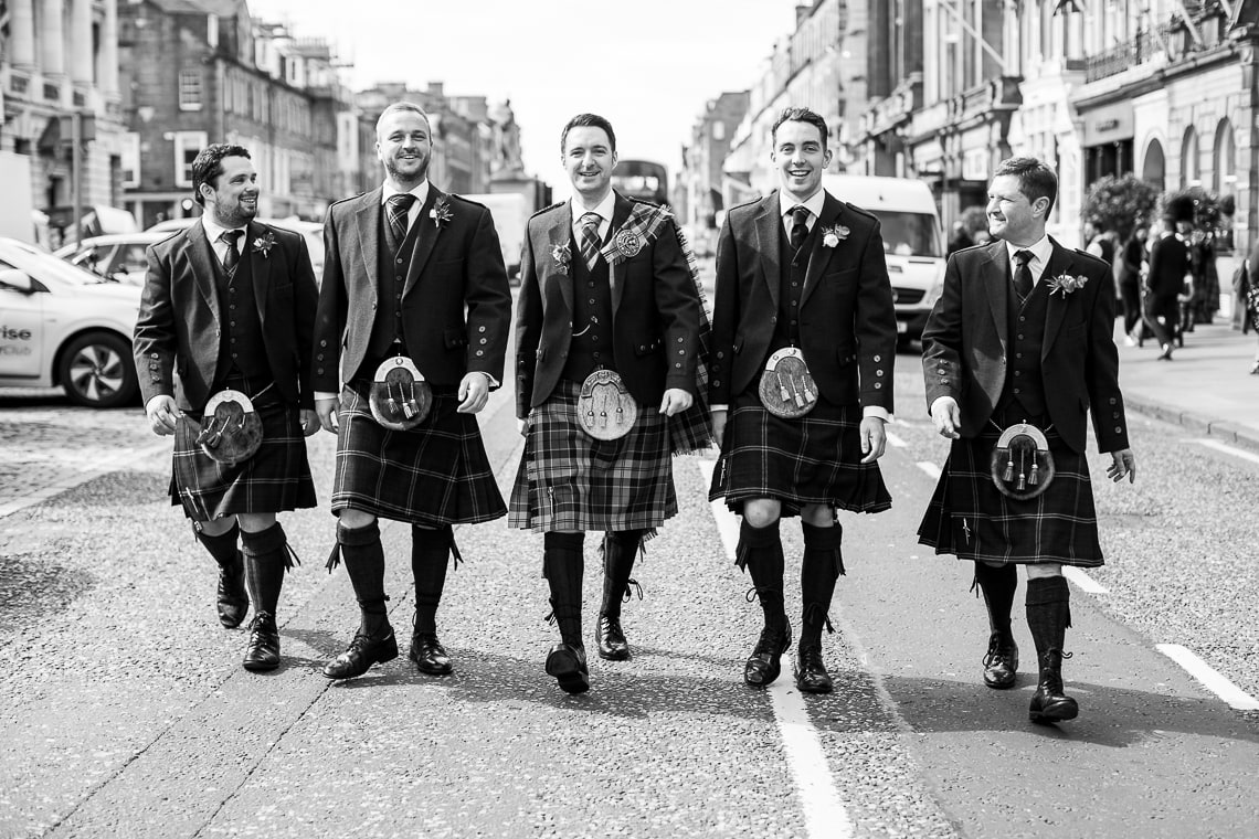 groom and groomsmen walking along George Street