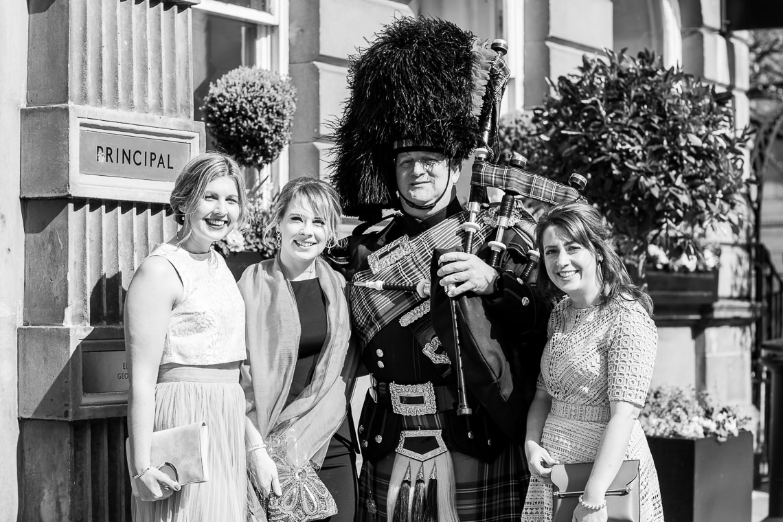 piper and female guests at the entrance to the George Hotel