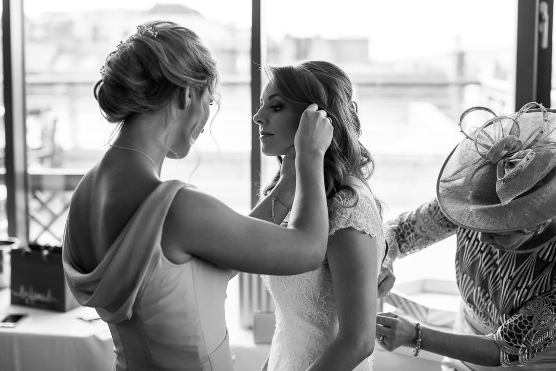 bridesmaid helping bride in the Forthview Suite