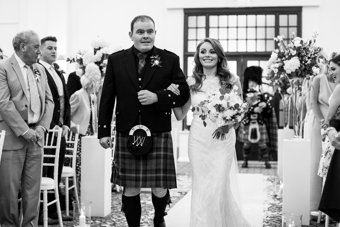 wedding processional bride escorted by her brother in the Kings Hall