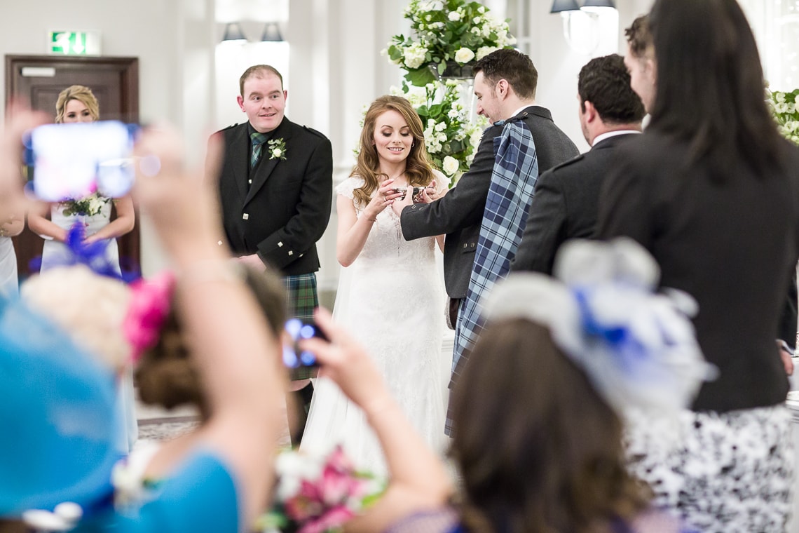 bride drinks whisky from a quaich