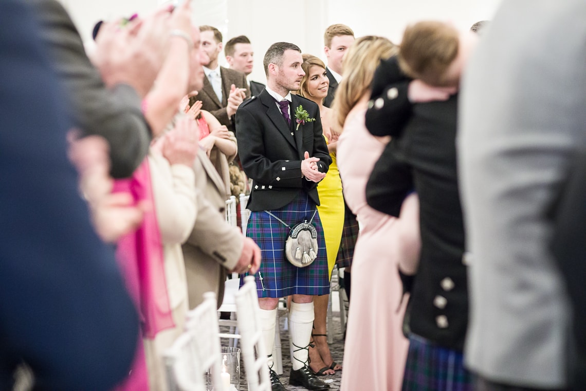 guests applaud the newlyweds