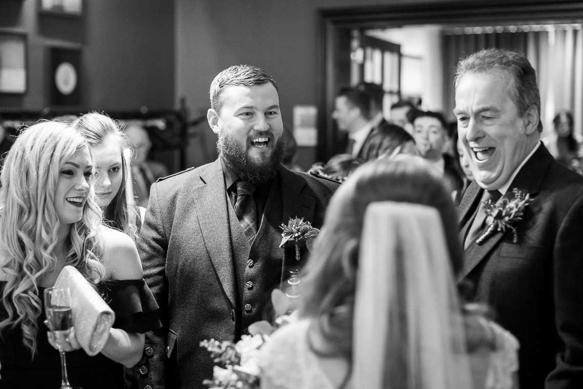 guest laughing with the bride in the Library