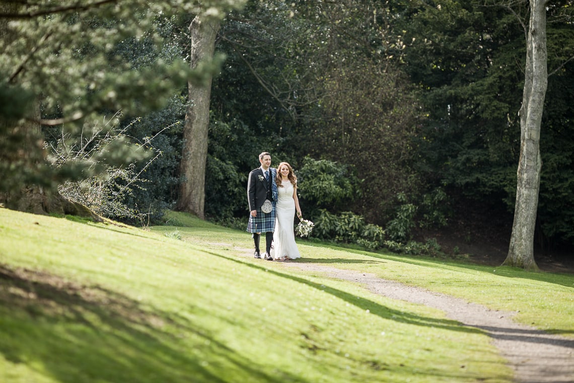 newlyweds walking in Queen Street Gardens