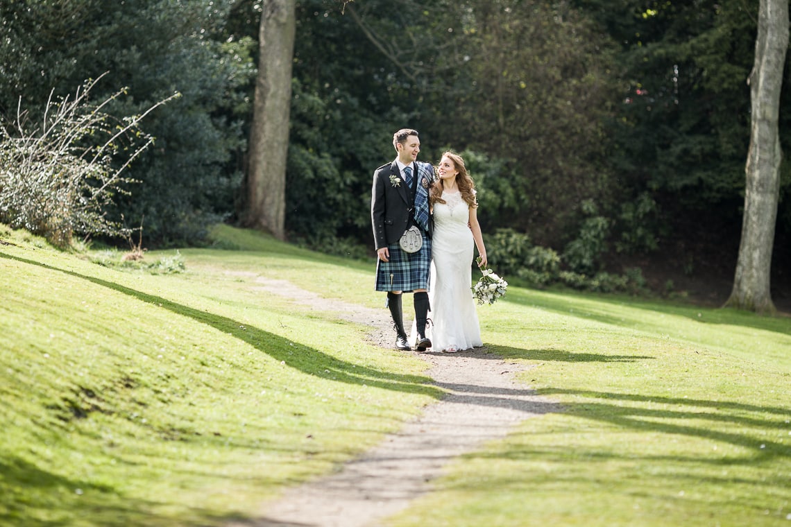 newlyweds walking in Queen Street Gardens