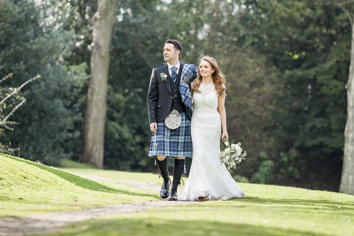 newlyweds walking in Queen Street Gardens