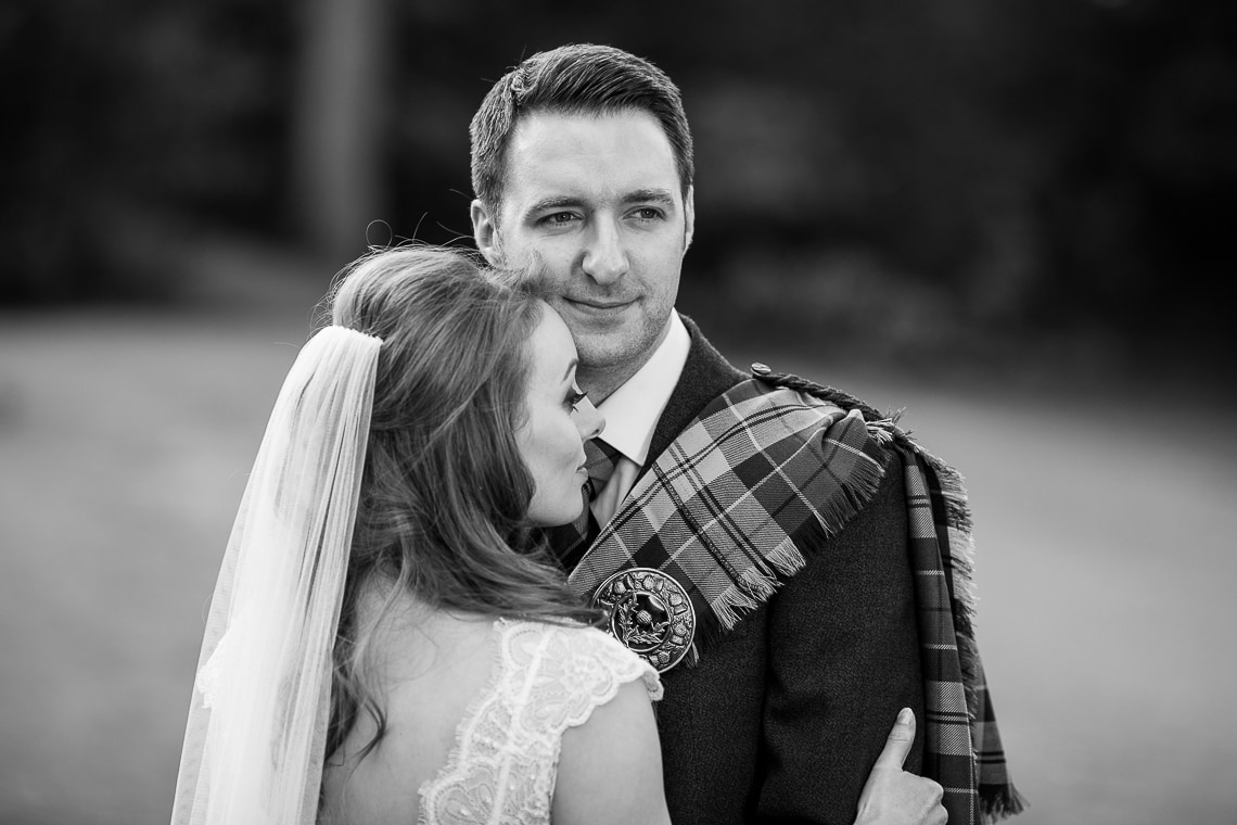 bride and groom embrace in Queen Street Gardens