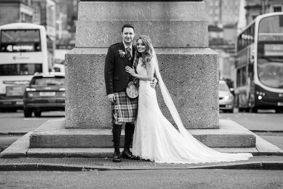 newlyweds embrace on the roundabout on George Street