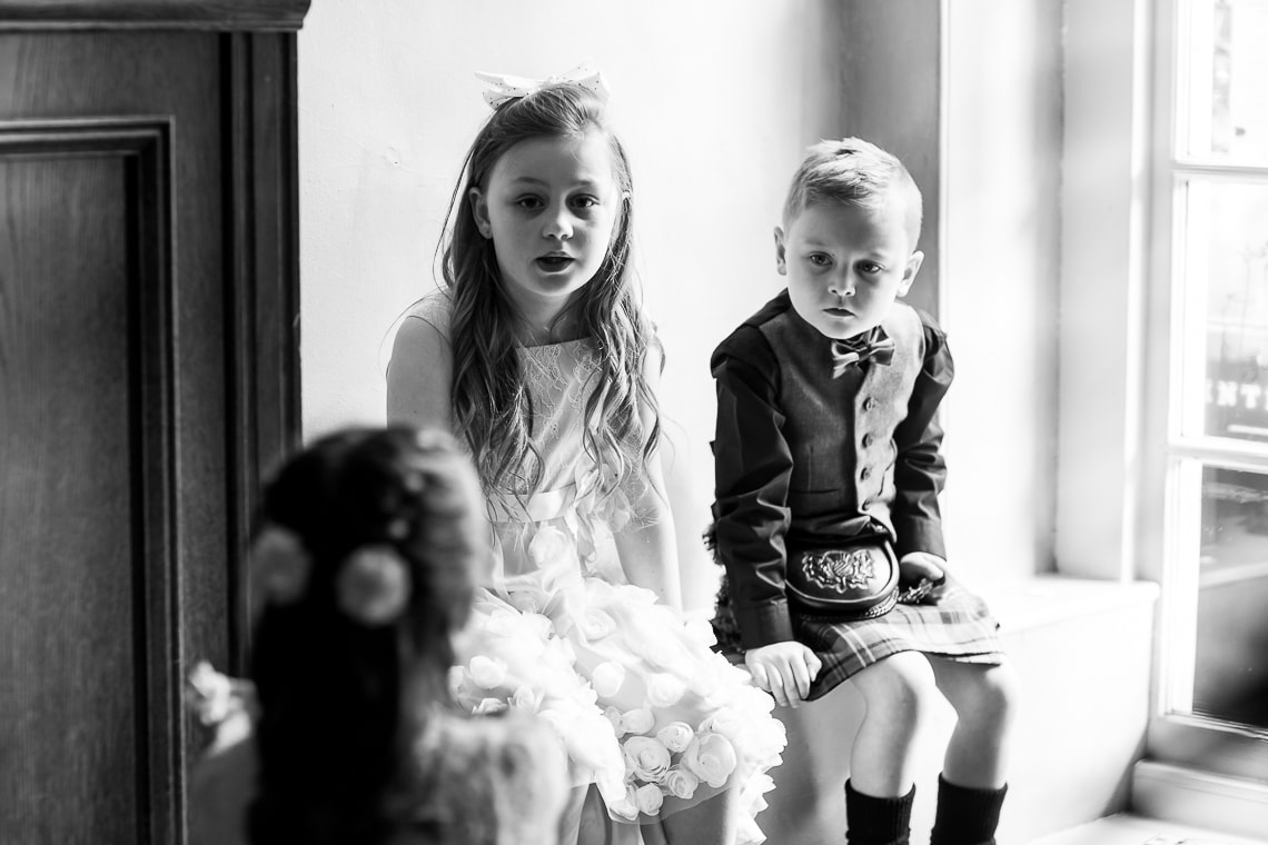 children sitting next to a window in the Library