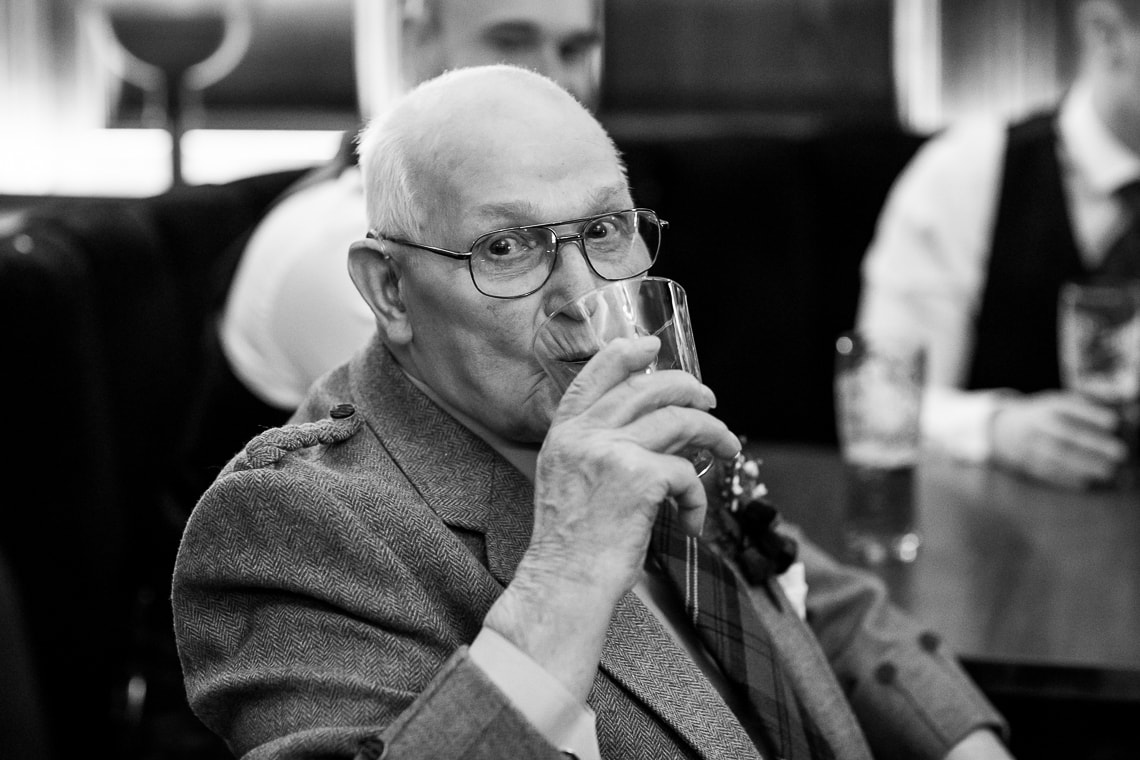 guest enjoys a drink in the Library