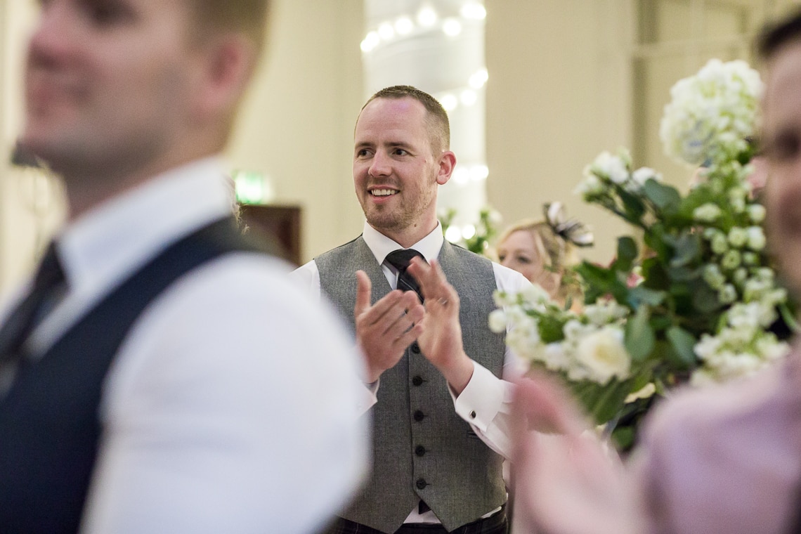 King's Hall guest applauds the entry of the top table guests