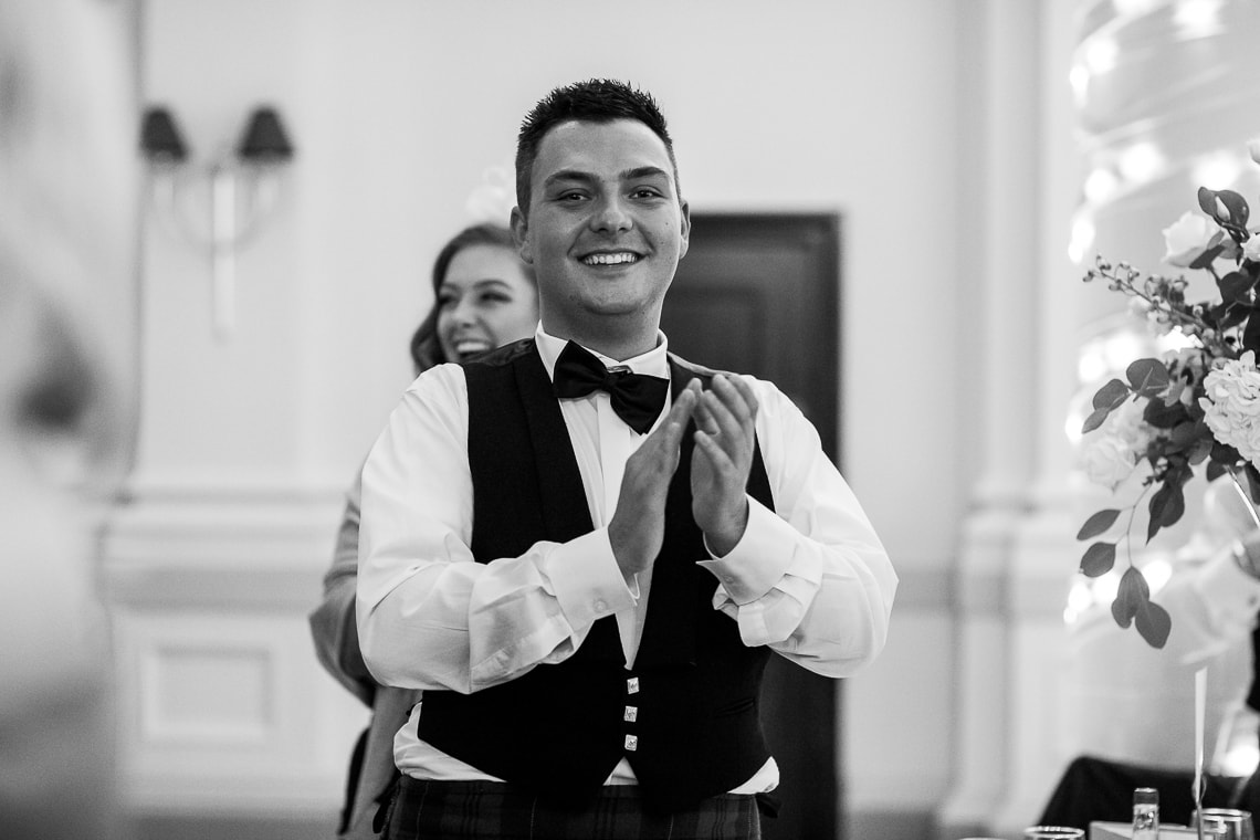 King's Hall guest applauds the entry of the top table guests