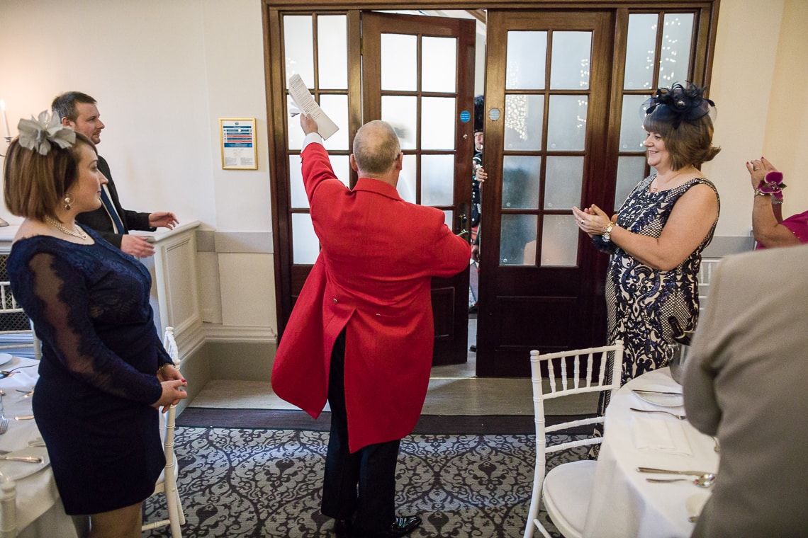 Toastmaster Maurice King announces the newlyweds into the King's Hall
