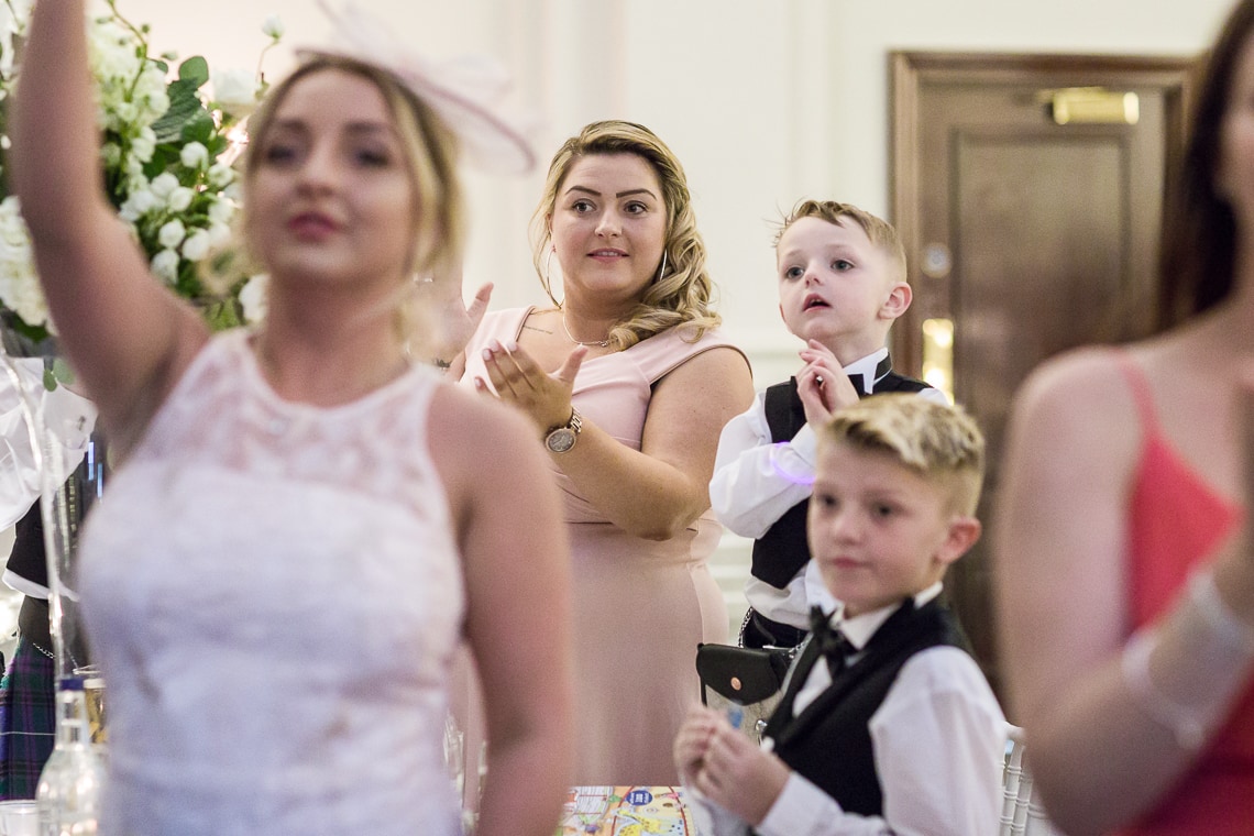 King's Hall guest applauds the entry of the newlyweds