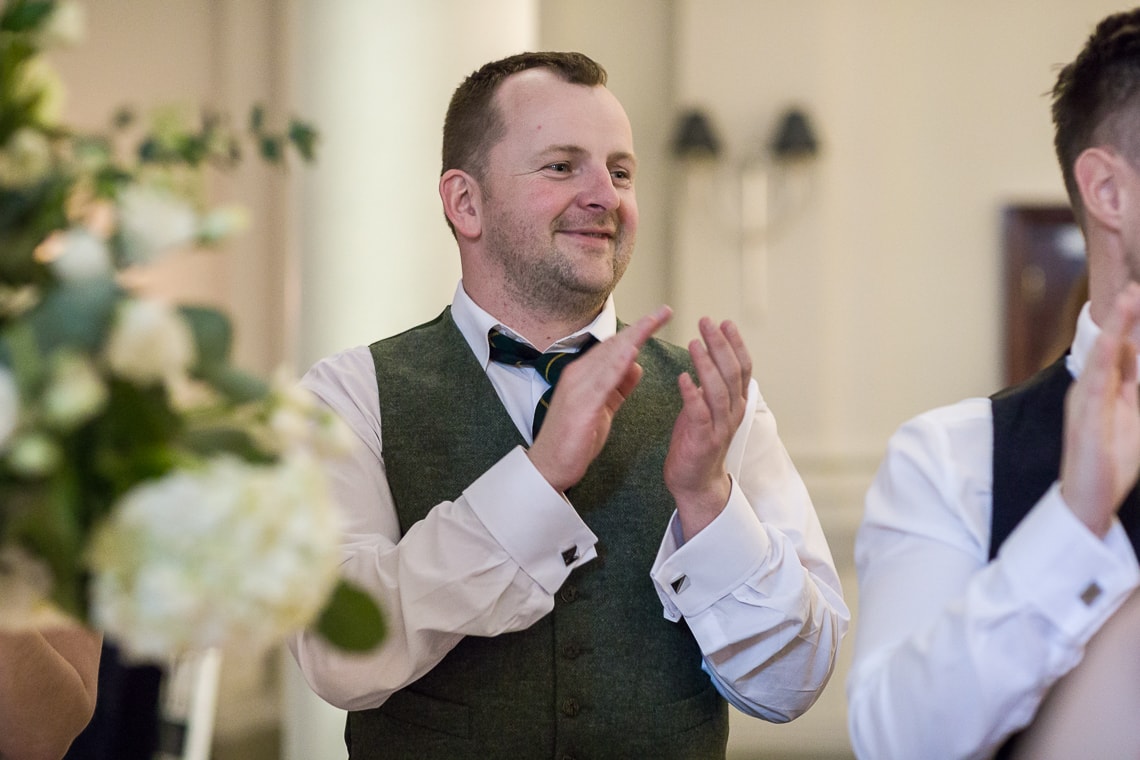 King's Hall guest applauds the entry of the newlyweds