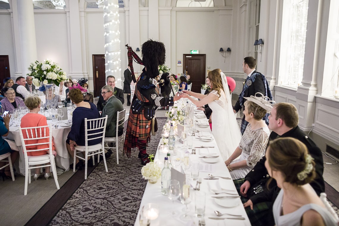 piper toast to the newlyweds in the King's Hall
