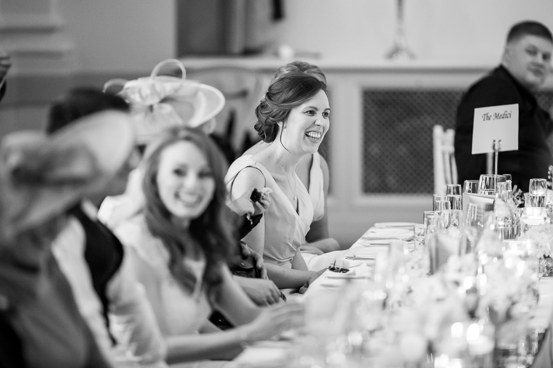 top table laughing during the best men speech in the King's Hall