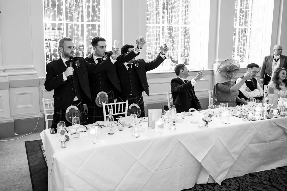 the best men raise a toast in the King's Hall