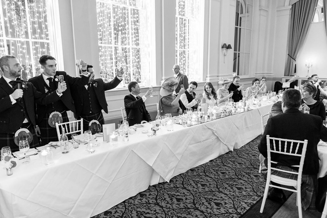 the best men raise a toast in the King's Hall