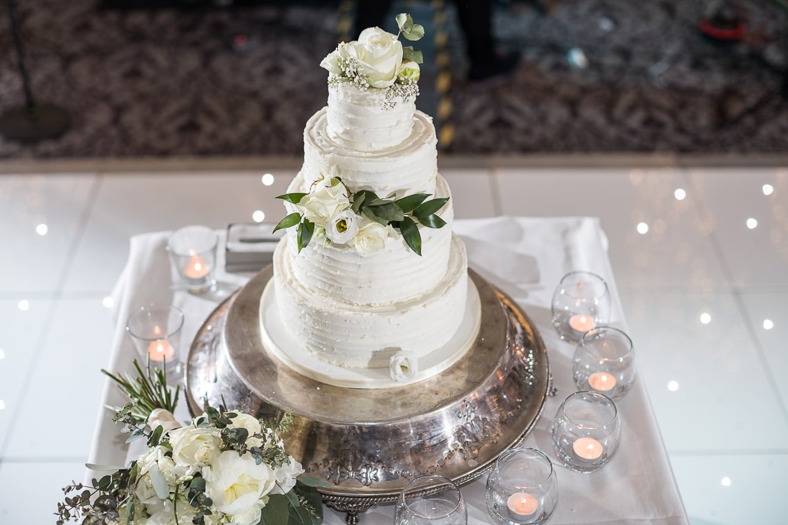 wedding cake on a table in the middle of the dancefloor in the King's Hall