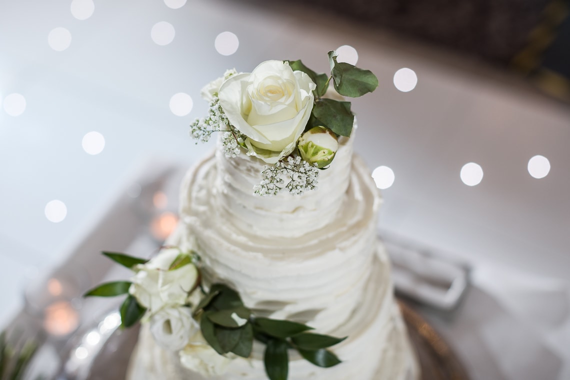 wedding cake on a table in the middle of the dancefloor in the King's Hall