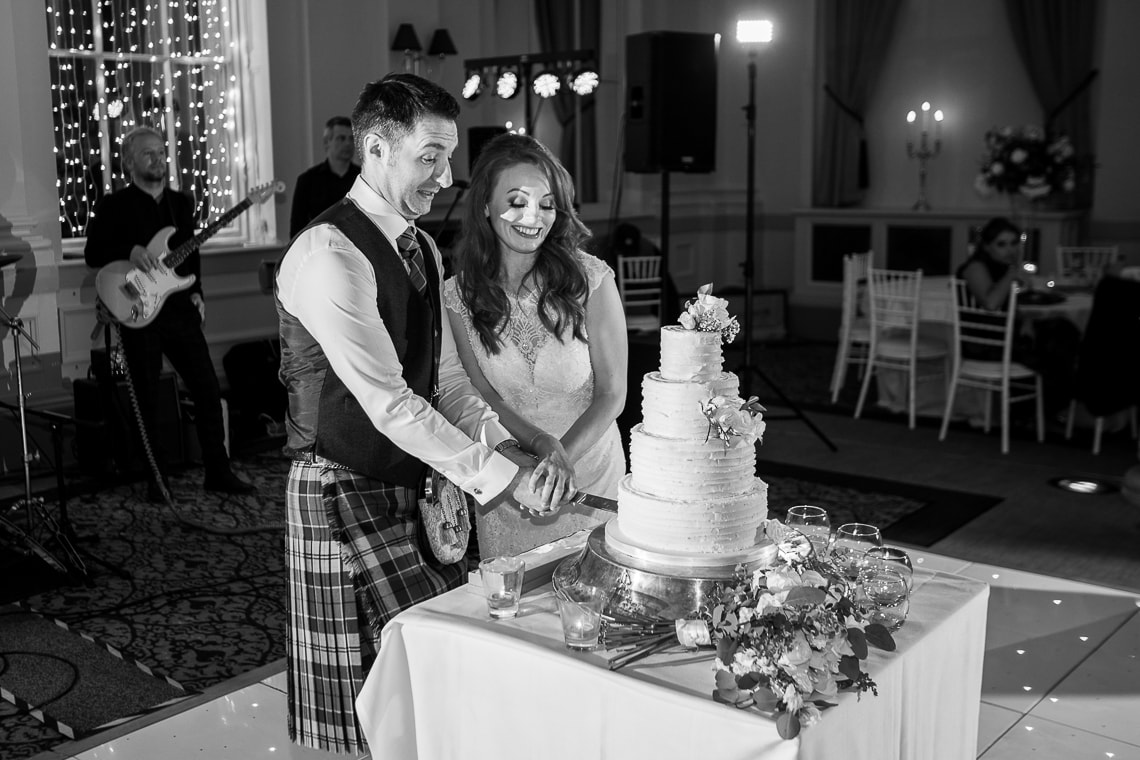 newlyweds cut the cake in the King's Hall