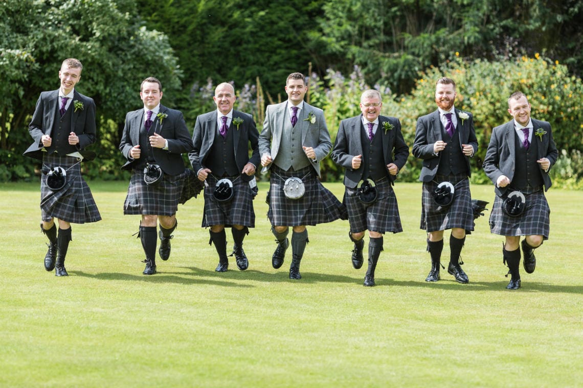 Groom and the boys charge on the lawn