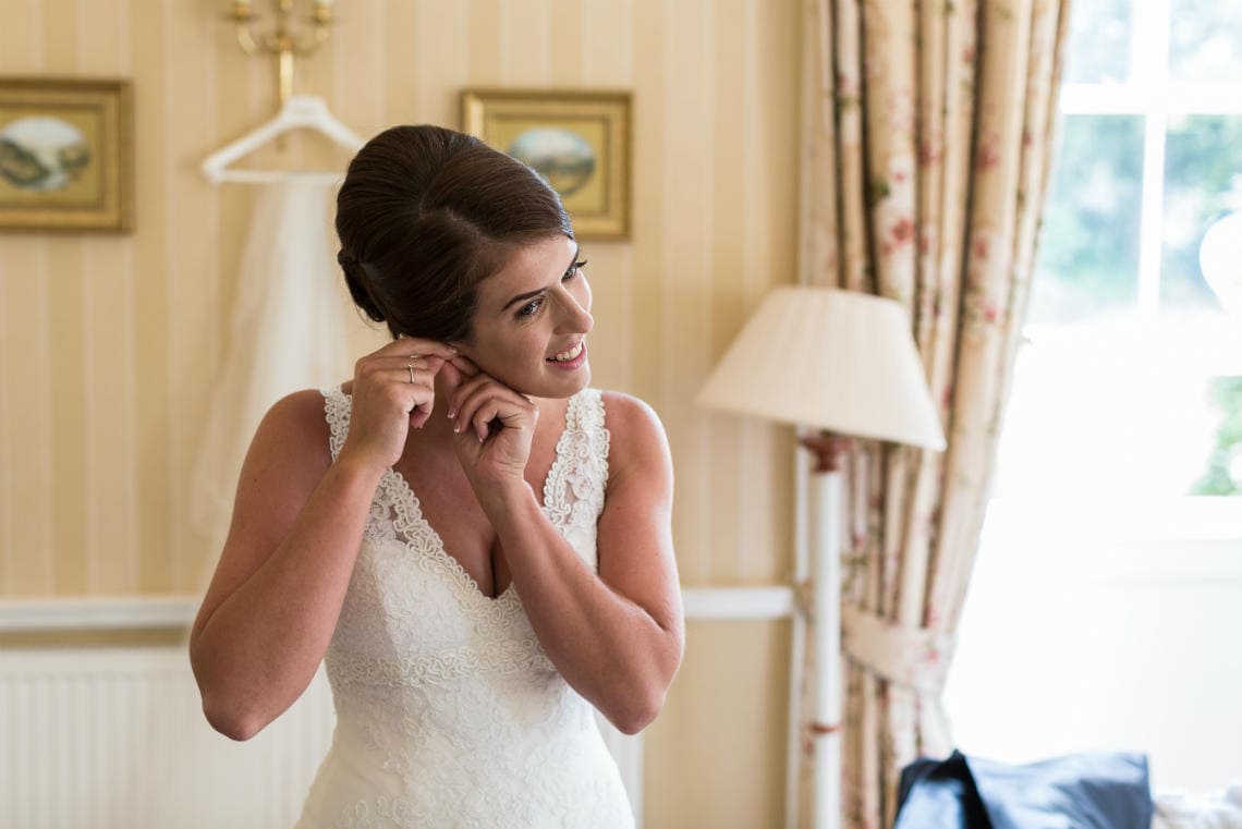 Bride pouts on her earrings