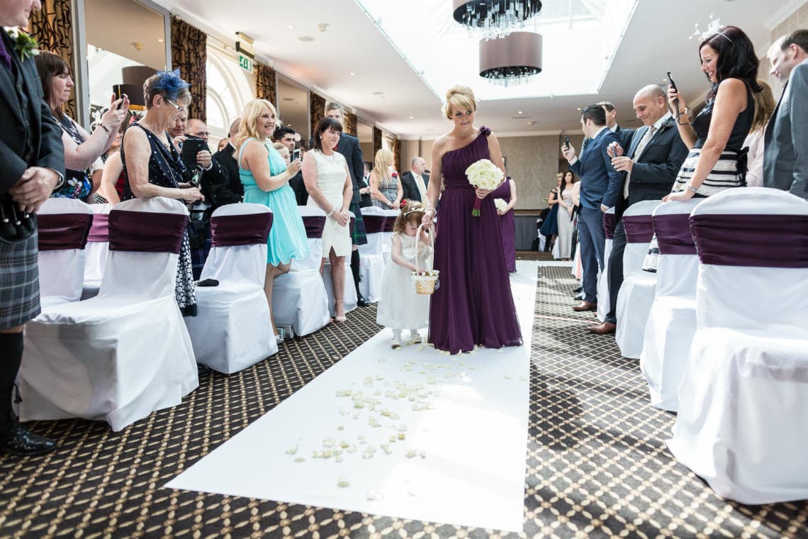 wedding processional bridesmaids walk up the aisle