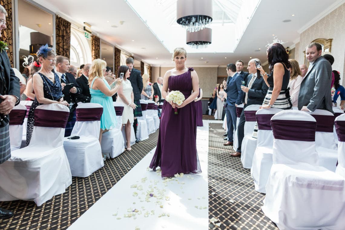 wedding processional bridesmaids walk up the aisle