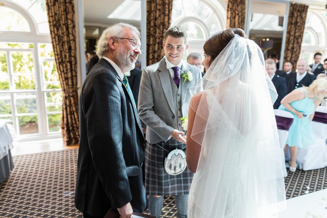 Celebrant welcomes everyone during \Humanist ceremony in The Ballroom