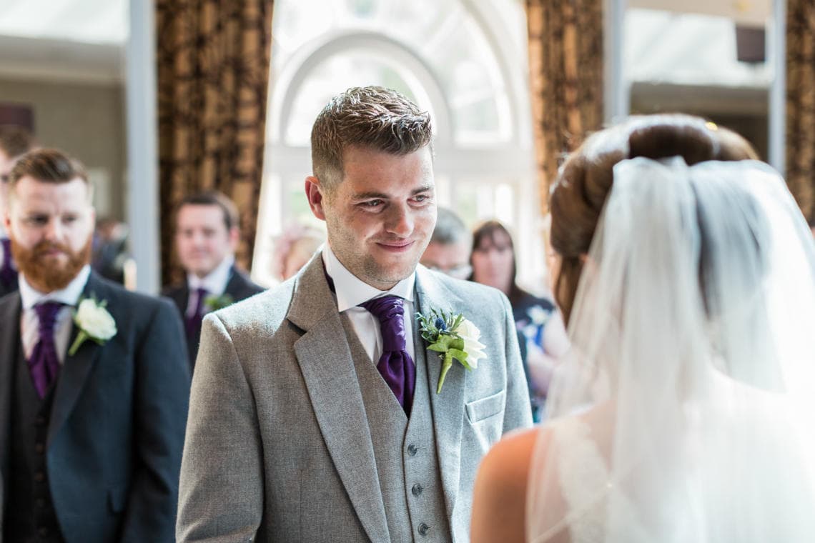 groom smiles at bride during Humanist ceremony in The Ballroom