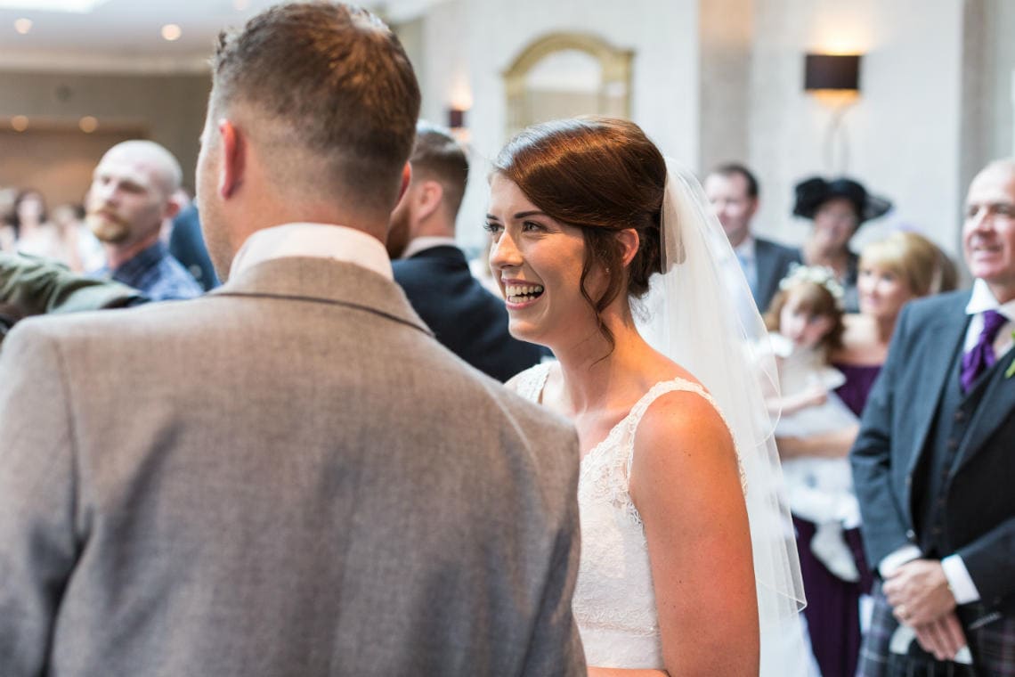 bride smiles as owl delivers the wedding rings