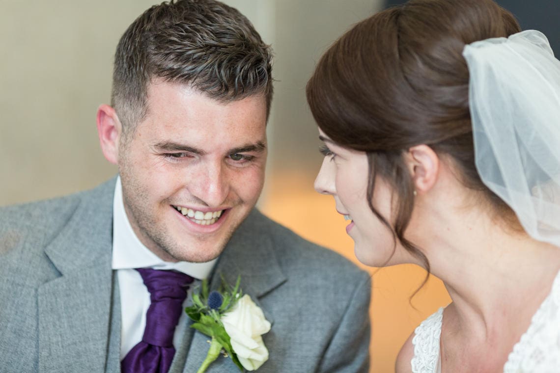 newlyweds smiling after signing the marriage schedule