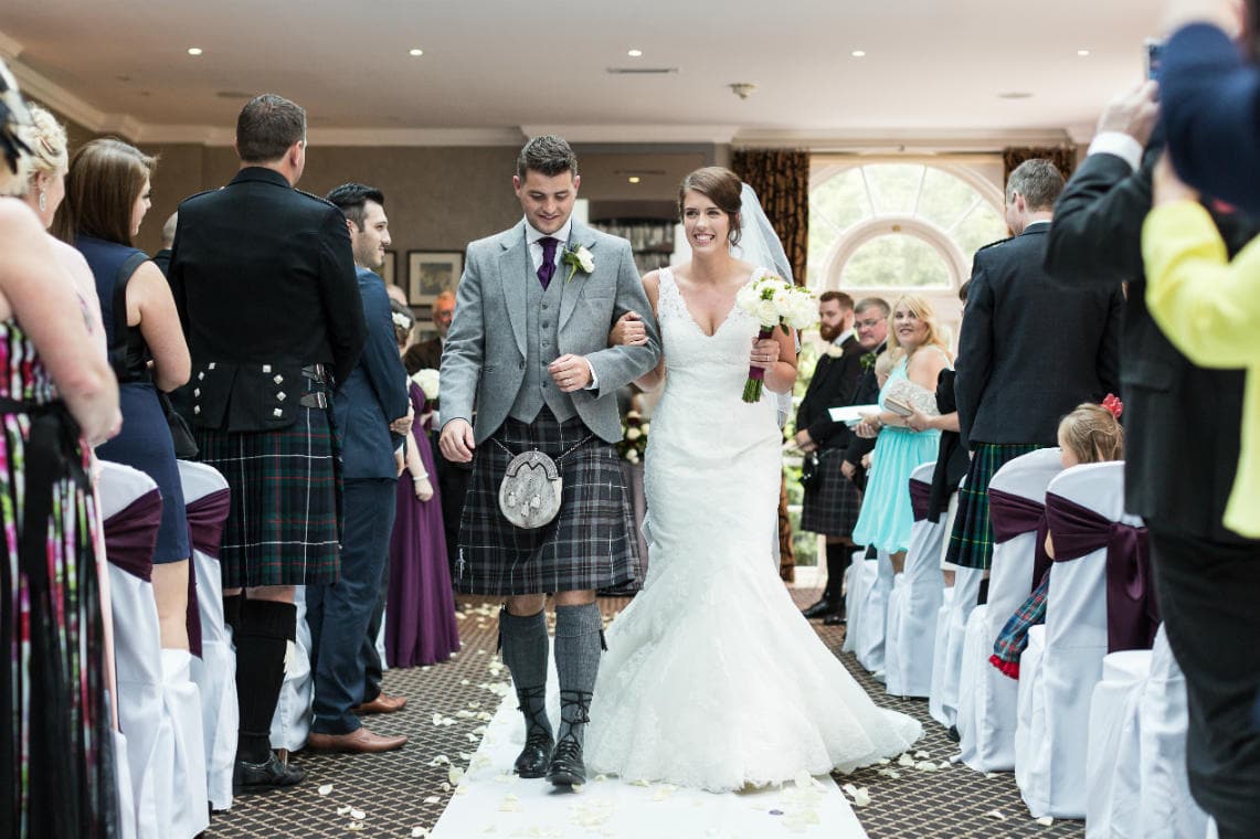 newlyweds walking up the aisle