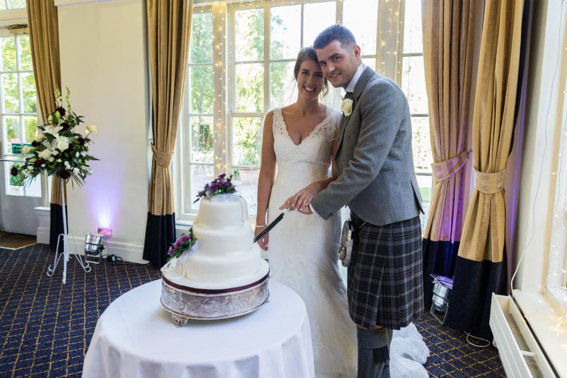 newlyweds cutting their cake