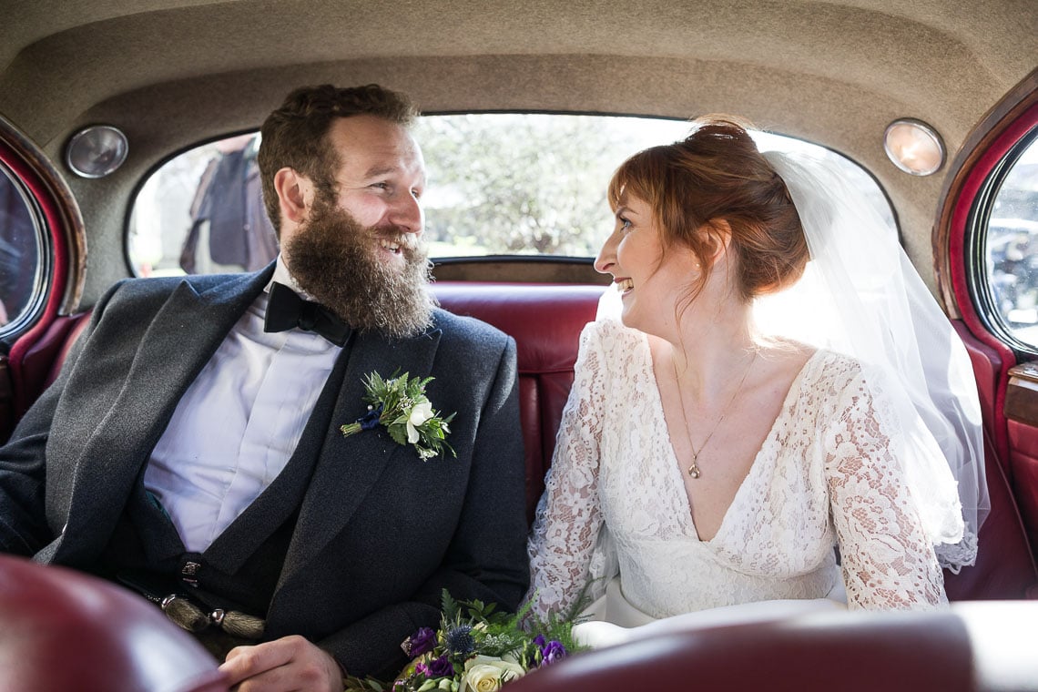 newlywed photo taken inside classic Jaguar car