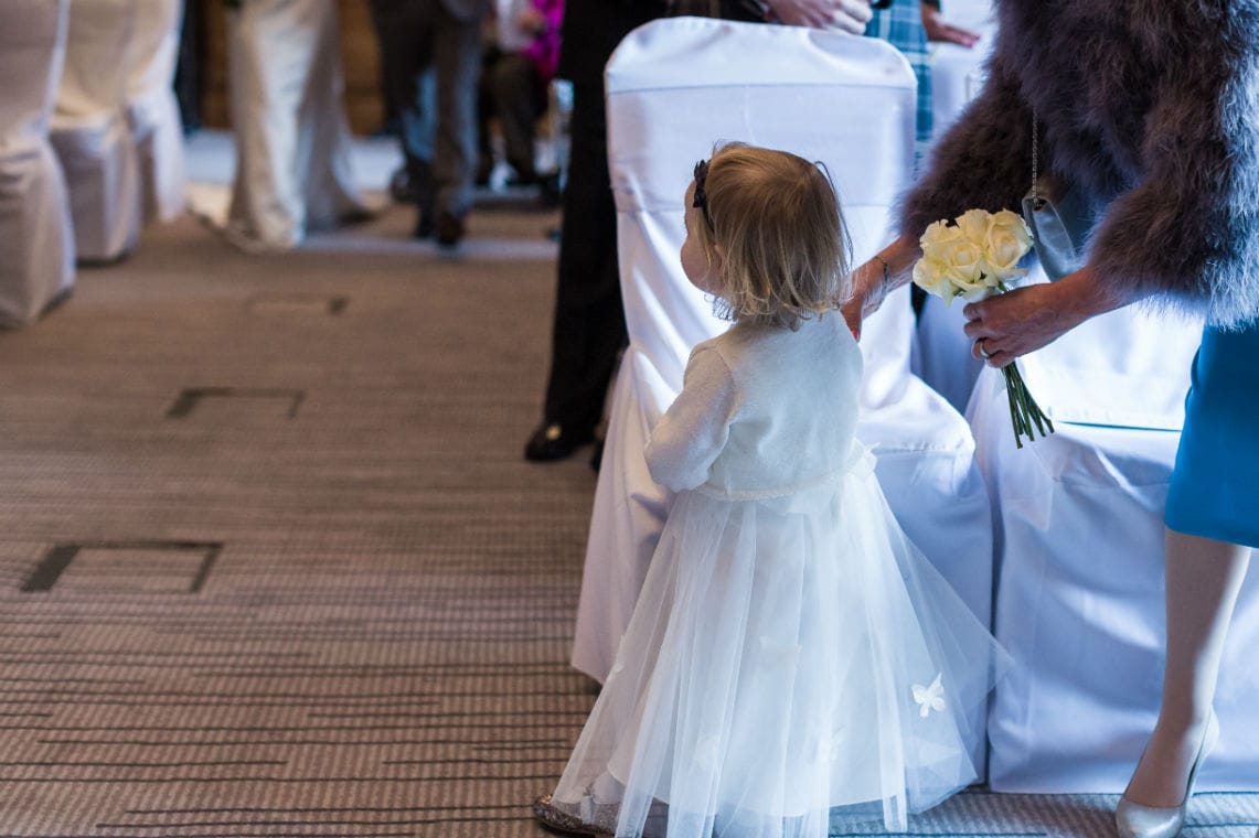 Bride's daughter watching her walk down the aisle