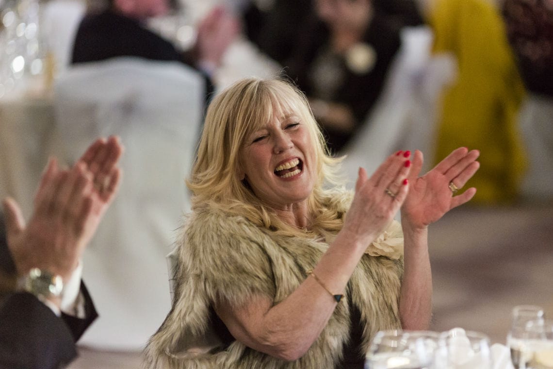 Lady laughing and clapping at speeches