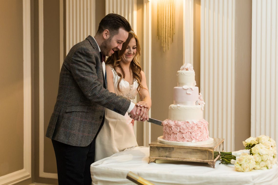 Newlyweds cutting their cake