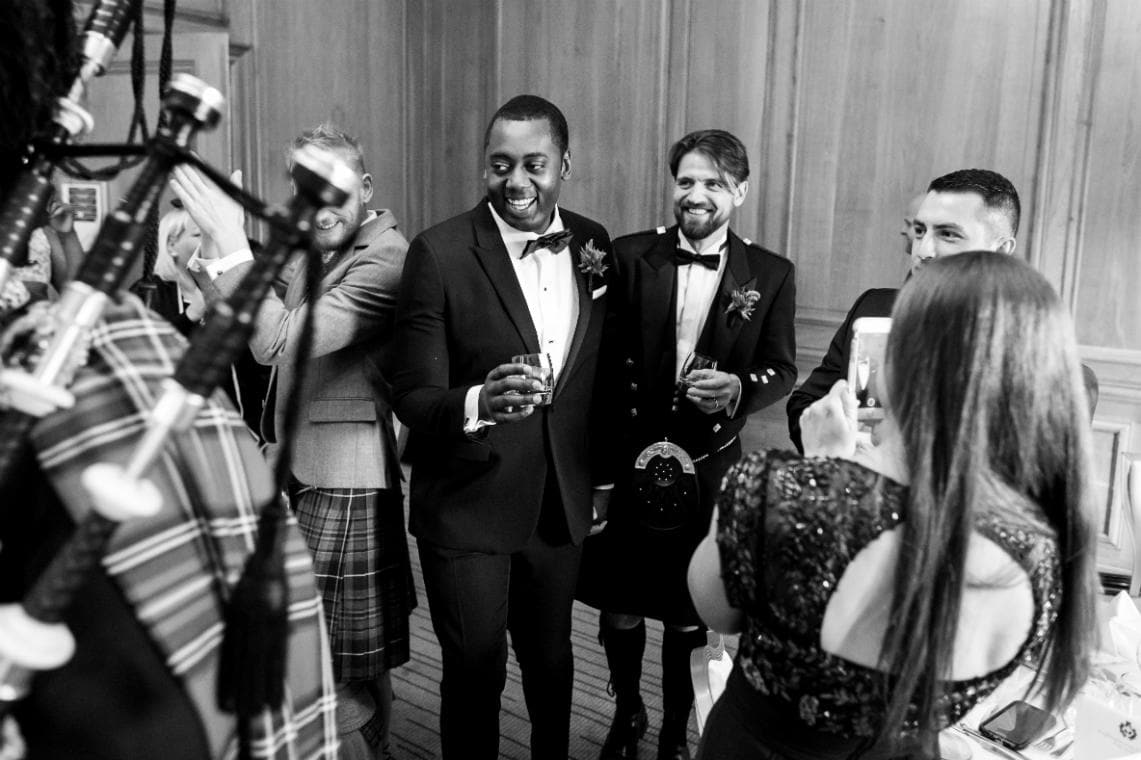 Pipe Major Iain Grant pipes newly-weds into The Boardroom